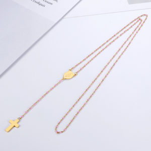 Chapelet catholique avec de petites perles roses sur une chaine dorées. Un pendentif en croix minimaliste doré et un médaillon doré gravé de la vierge marie